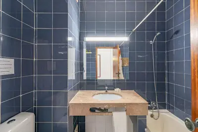 a blue tiled bathroom with a sink and a tub at Eirasol by Umbral in Albufeira