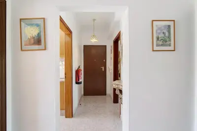 a hallway with a door and two pictures on the wall at Golden Rana Apartment in Albufeira
