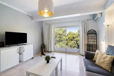 a living room with a couch and a tv at Golden Rana Apartment in Albufeira