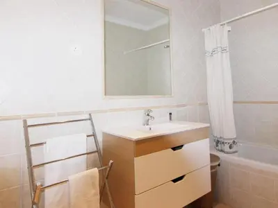 a bathroom with a sink and a mirror at Los Arcos Apartment I in Vilamoura