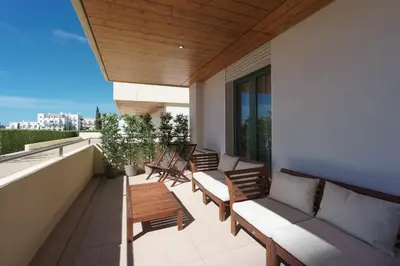 a balcony with chairs and a table on a building at Marina Vilamoura - Aquamar 003 By Vilamoura Sun in Vilamoura