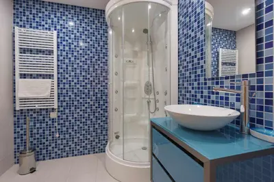 a blue tiled bathroom with a sink and a shower at Marina Vilamoura - Aquamar 003 By Vilamoura Sun in Vilamoura