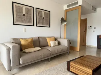 a living room with a couch and a table at Marina Vilamoura - Aquamar 209 - By Vilamoura Sun in Vilamoura