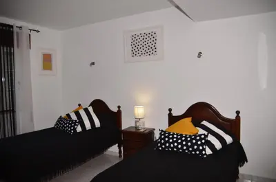 a bedroom with two beds with pillows on them at Villa Batista in Guia