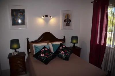 a bedroom with a bed with pillows on it at Villa Batista in Guia