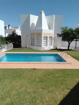 a swimming pool in front of a house at Elegant Villa in Albufeira with Private Pool. in Albufeira