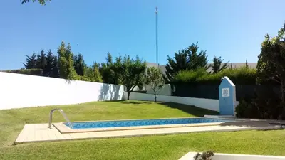 a swimming pool in a yard next to a fence at Elegant Villa in Albufeira with Private Pool. in Albufeira
