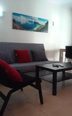 a living room with a couch and a coffee table at Salgados Village T1 in Albufeira