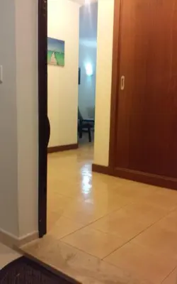 a hallway with a door and a tile floor at Salgados Village T1 in Albufeira