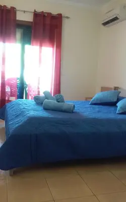 a blue bed with two pillows on top of it at Salgados Village T1 in Albufeira