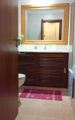a bathroom with a sink and a mirror at Salgados Village T1 in Albufeira