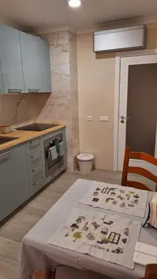 a kitchen with a table and a toilet in it at The Market Square House in Faro