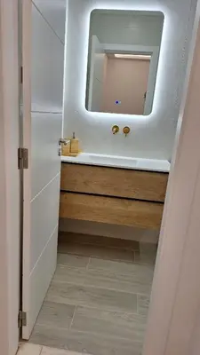 a bathroom with a sink and a mirror at The Market Square House in Faro