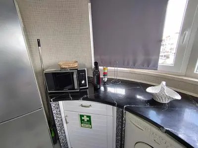 a living room with a flat screen tv on a table at Albufeira INN - CORAL T1 in Albufeira