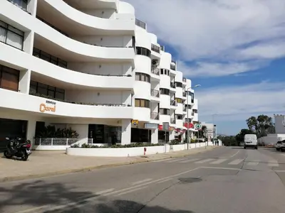 a person holding a cell phone in their hand at Albufeira INN - CORAL T1 in Albufeira