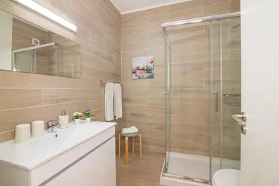 a bathroom with a sink and a shower at Beti Oura Village in Albufeira