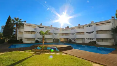 a large building with a swimming pool in front of it at Palmeiras do Golfe 160 - Clever Details in Vilamoura