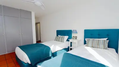 two beds in a room with blue and white at Palmeiras do Golfe 160 - Clever Details in Vilamoura