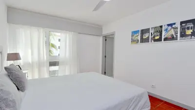 a white bedroom with a bed and a window at Palmeiras do Golfe 160 - Clever Details in Vilamoura