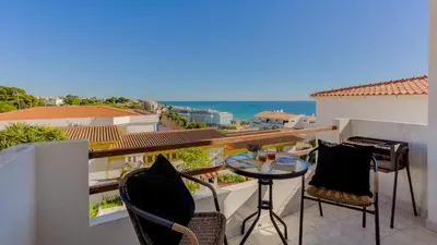 a balcony with a table and chairs and the ocean at ★ Sea View ★ 1 Minute to Oldtown and Beach ★ in Albufeira