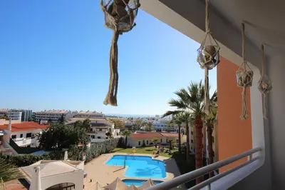 a view from the balcony of a resort with a swimming pool at MAIN AVENUE ALBUFEIRA, walk to beach, Old Town, shooping, top location in Albufeira