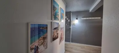a hallway with pictures on the walls of a room at MAIN AVENUE ALBUFEIRA, walk to beach, Old Town, shooping, top location in Albufeira