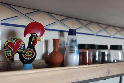 a figurine of a chicken sitting on a shelf at MAIN AVENUE ALBUFEIRA, walk to beach, Old Town, shooping, top location in Albufeira