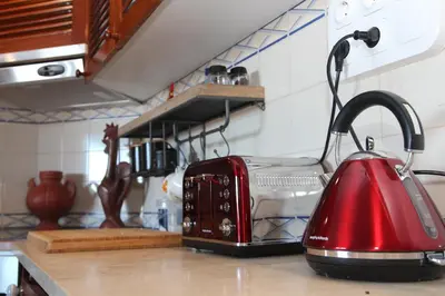 a red toaster sitting on top of a kitchen counter at MAIN AVENUE ALBUFEIRA, walk to beach, Old Town, shooping, top location in Albufeira