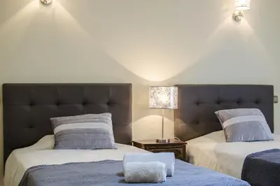 a bedroom with two beds and a lamp at Villa Valentina in Almancil