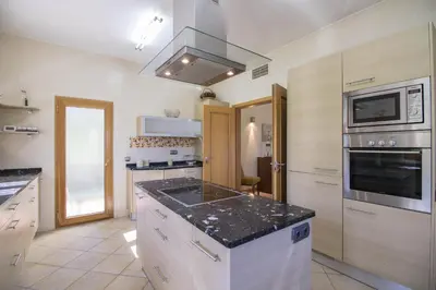 a kitchen with a counter top and a stove top oven at Villa Valentina in Almancil