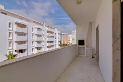 an empty balcony of a white apartment building at Atlântico View - Beach front - Quarteira in Quarteira