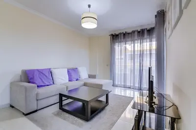 a living room with a couch and a table at Forte Novo - Modern apartment - Quarteira in Quarteira