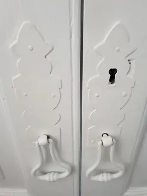 two white doors with a hole in the middle at Old Charming House Faro in Faro