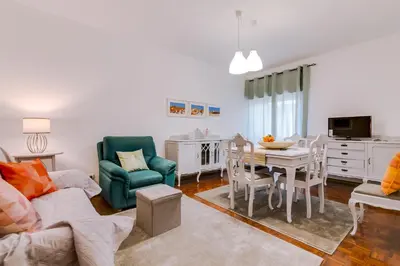 a living room with a couch and a table and chairs at Casa da Esquina - Faro city center in Faro