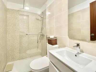 a bathroom with a sink and a toilet and a shower at Casa da Esquina - Faro city center in Faro