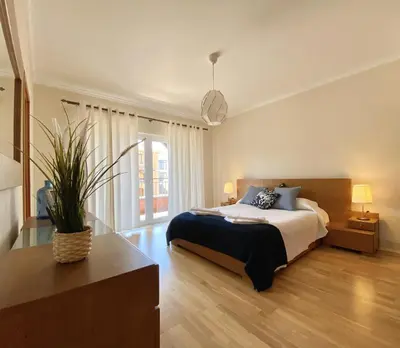 a bedroom with a bed and a potted plant at Amazing 2Bedroom apartment in Victoria Boulevard in Vilamoura