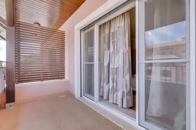 a room with a large window with blinds at Amazing 2Bedroom apartment in Victoria Boulevard in Vilamoura