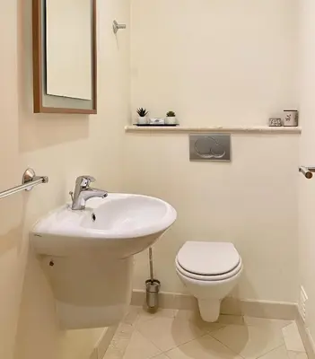 a white bathroom with a toilet and a sink at Amazing 2Bedroom apartment in Victoria Boulevard in Vilamoura