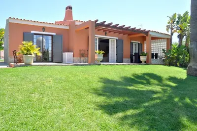 a villa with a driveway in front of a house at Fantastic for Family Gatherings, Optional Pool Heating, Free Air Con Wifi in Quarteira
