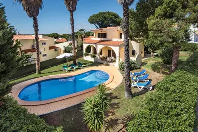 a hotel room with two beds and a balcony at Exclusive Retreat in Vilamoura, private pool, off-street parking, Free AC wifi in Quarteira