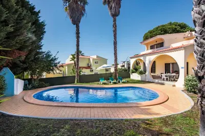 an outdoor dining room with a table and chairs at Exclusive Retreat in Vilamoura, private pool, off-street parking, Free AC wifi in Quarteira