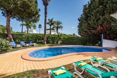 a bedroom with a bed and a large window at Exclusive Retreat in Vilamoura, private pool, off-street parking, Free AC wifi in Quarteira