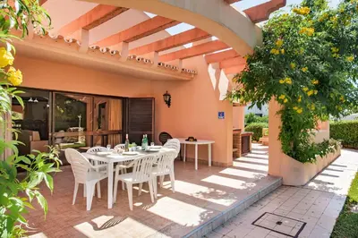 a swimming pool with lounge chairs and an umbrella at 5 En-Suite Bedrooms, close to centre, free AC WiFi in Loulé