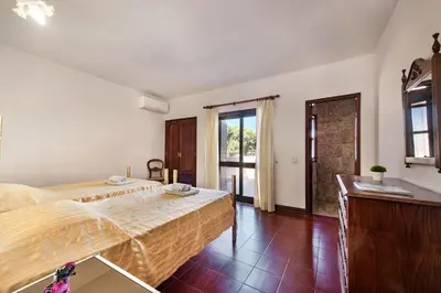 a bedroom with a bed and a dresser at 5 En-Suite Bedrooms, close to centre, free AC WiFi in Loulé