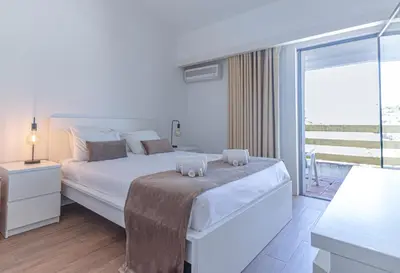 a hotel room with a bed and a balcony at Casa Moura Golfe in Vilamoura
