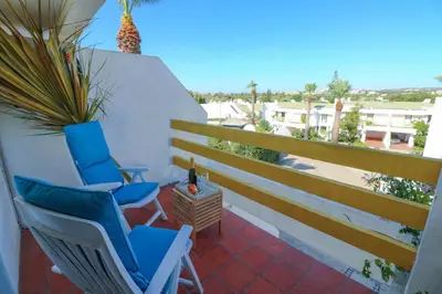 a pair of chairs on a balcony with a view at Casa Moura Golfe in Vilamoura
