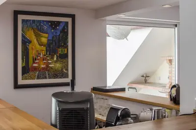 a living room with a white couch and a fireplace at Casa Oliveira in Loulé