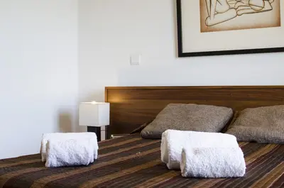 a bedroom with a bed with two towels on it at Casa Oliveira in Loulé