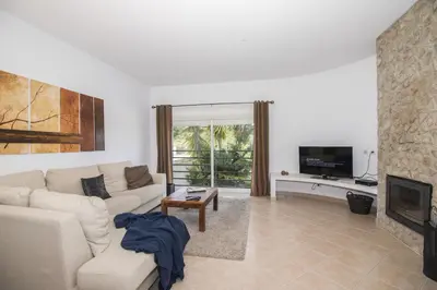 a bedroom with a bed with a dresser and a mirror at Casa Oliveira in Loulé