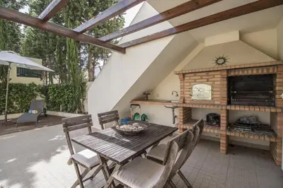 a living room with a white couch and a table at Casa Oliveira in Loulé